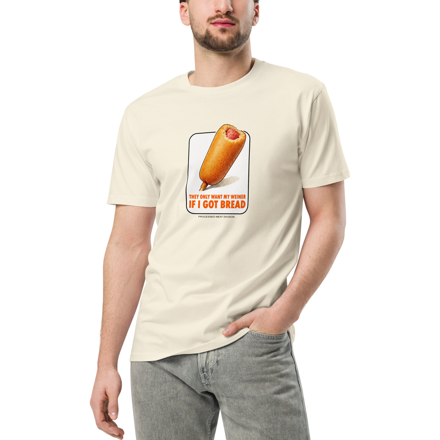 Person wearing a cream t-shirt with a corn dog graphic and text on a white background
