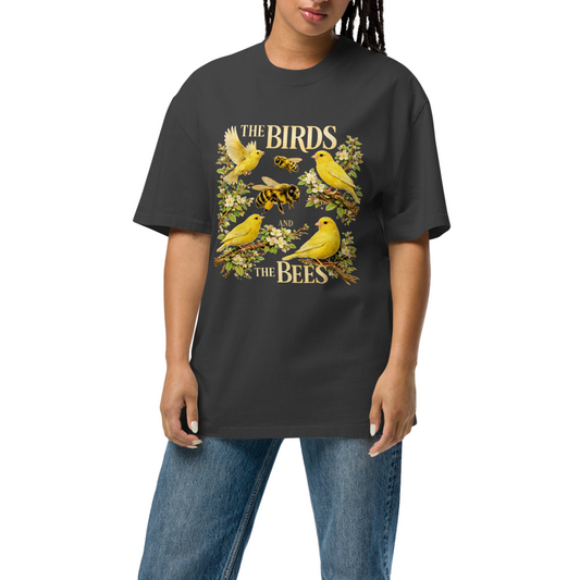 Person wearing a black t-shirt with a graphic design of birds and bees on a white background