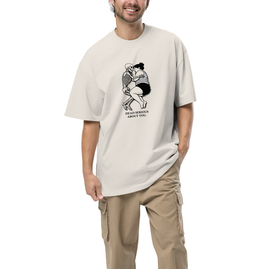 Man wearing a beige t-shirt with a graphic design on a white background