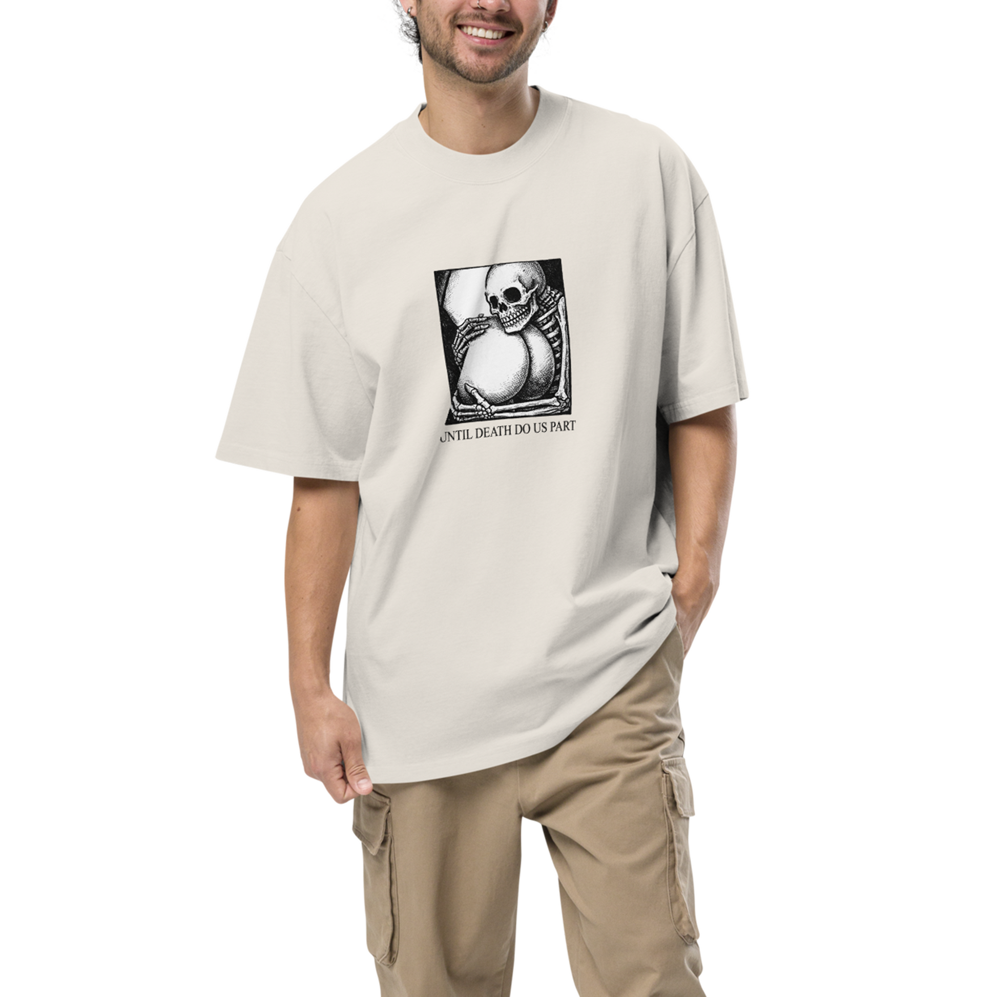Man wearing a beige t-shirt with a graphic design on a white background
